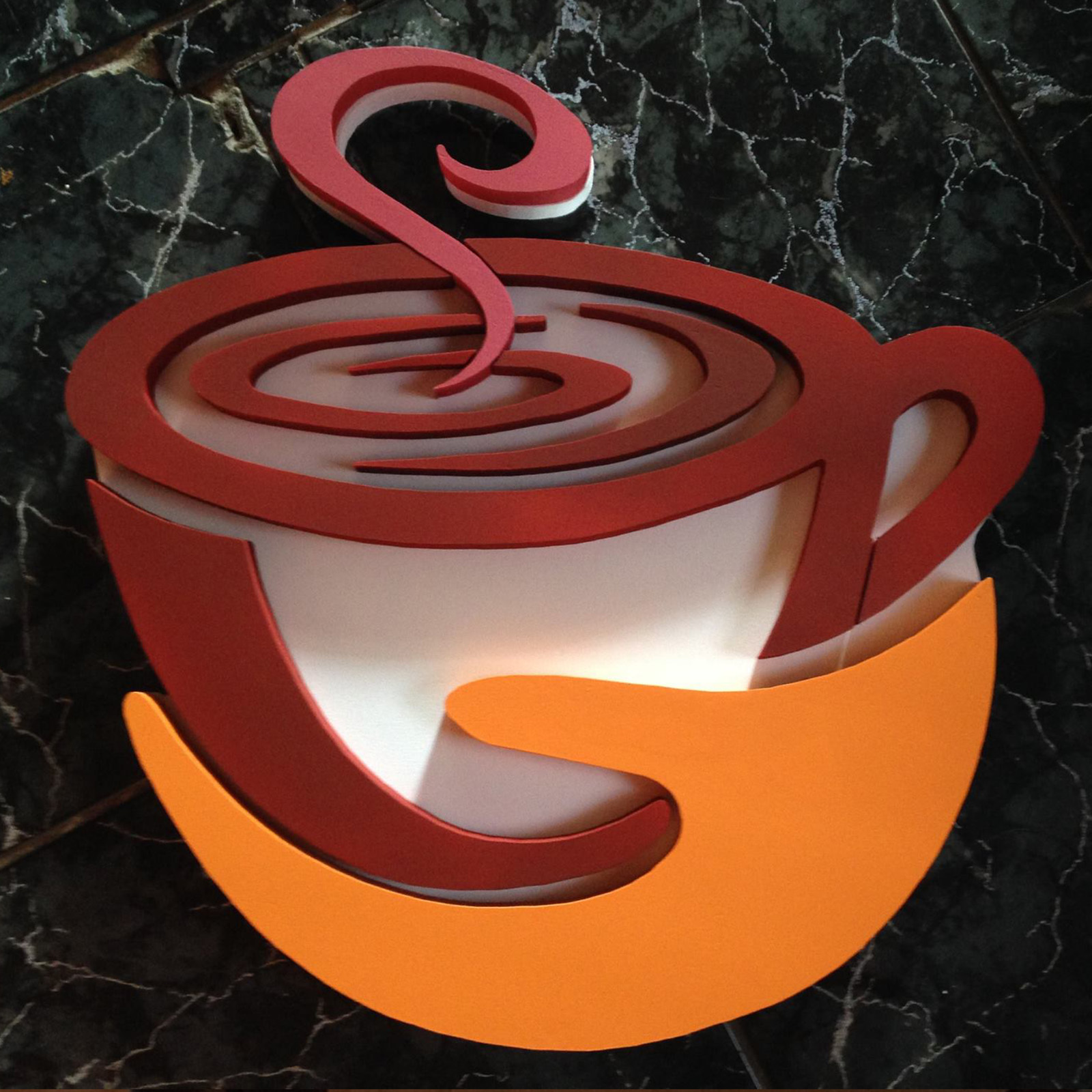 Logo din polistiren montat pe perete într-o cafenea